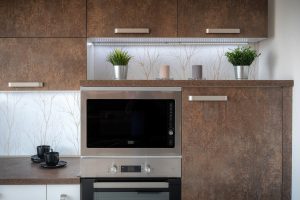 Modern kitchen renovation featuring sleek countertops, open shelving, and contemporary appliances.