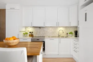 Modern kitchen transformation by NuView Construction in University City, showcasing sleek quartz  modern countertops, custom cabinetry with handle-less designs, durable flooring, and energy-efficient LED lighting. The space highlights contemporary urban living with an elegant and functional design, ideal for small apartments and compact homes.