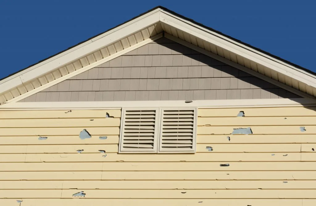 A close-up view of siding damage on a Philadelphia home, highlighting cracks and peeling. Essential for understanding siding repair and maintenance to prevent further issues. For expert siding repair, contact [Your Company Name] to ensure long-lasting protection and a fresh exterior look.