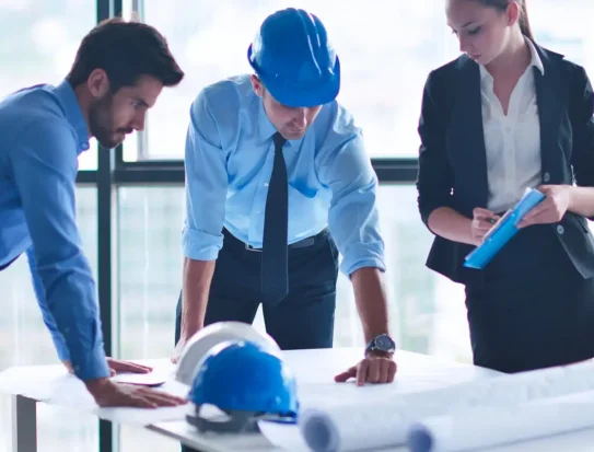 business people group on meeting and presentation  in bright modern office with construction engineer architect and worker looking building model and blueprint planbleprint plans