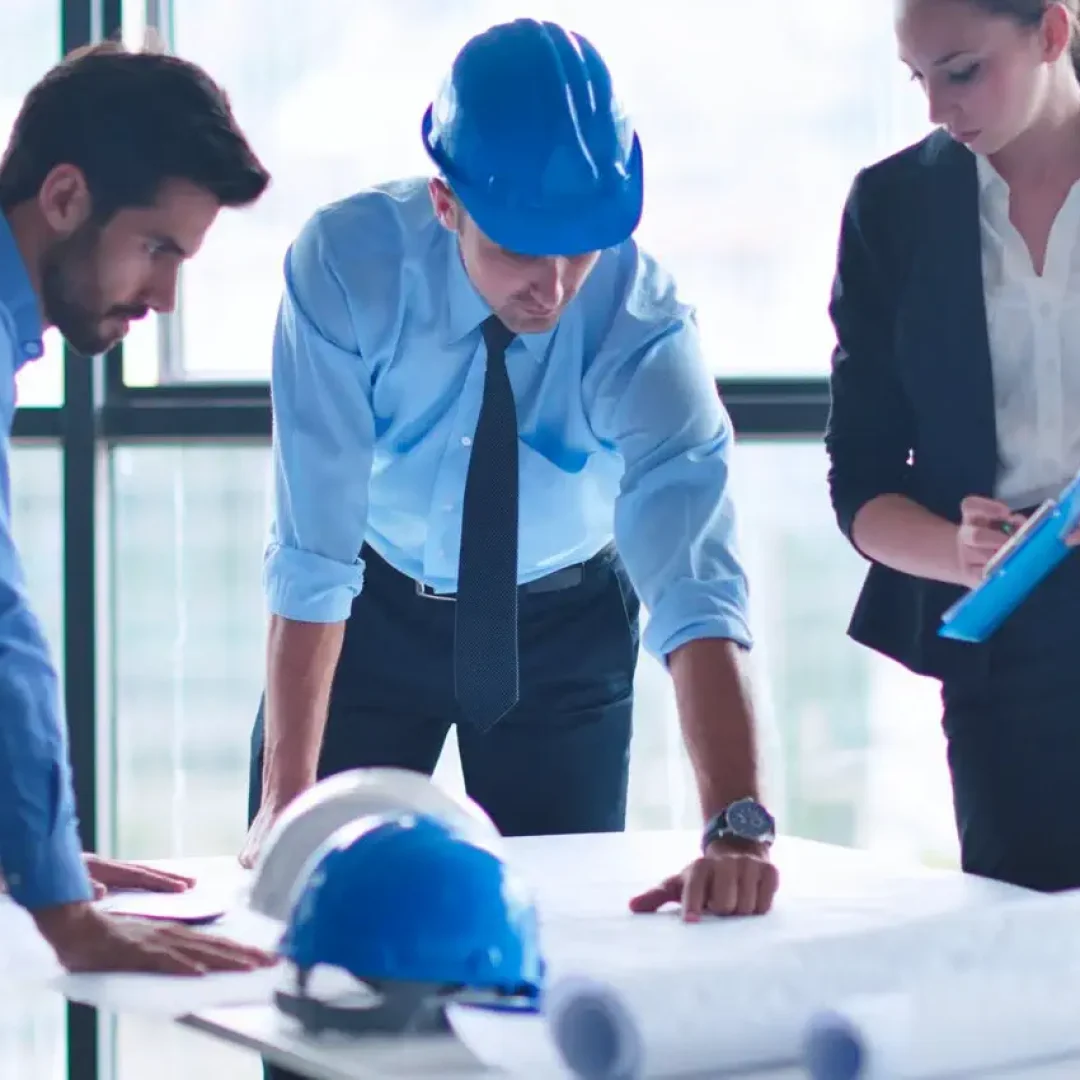 business people group on meeting and presentation  in bright modern office with construction engineer architect and worker looking building model and blueprint planbleprint plans